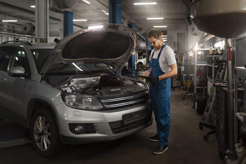 male mechanic working shop car
